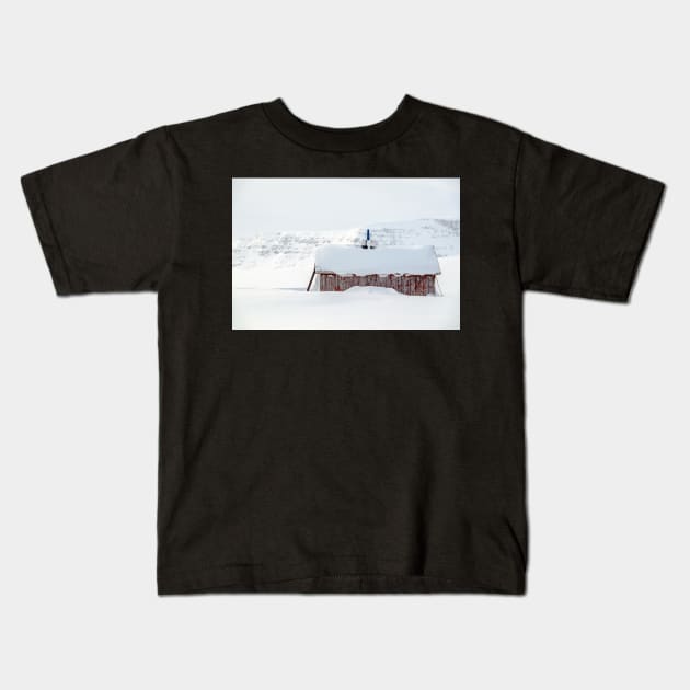 Snow covered Sami cabin in the mountains of Lapland Kids T-Shirt by geoffshoults